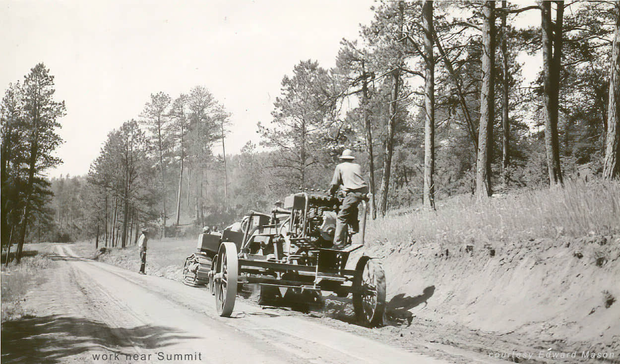 men grading a road