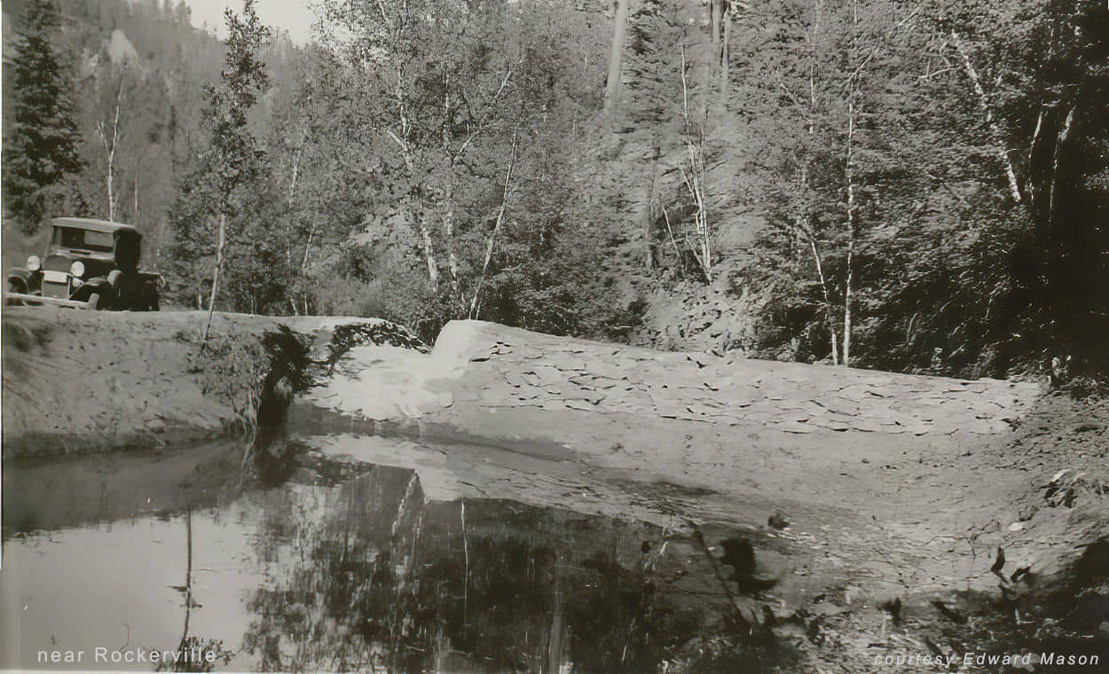car by small dam