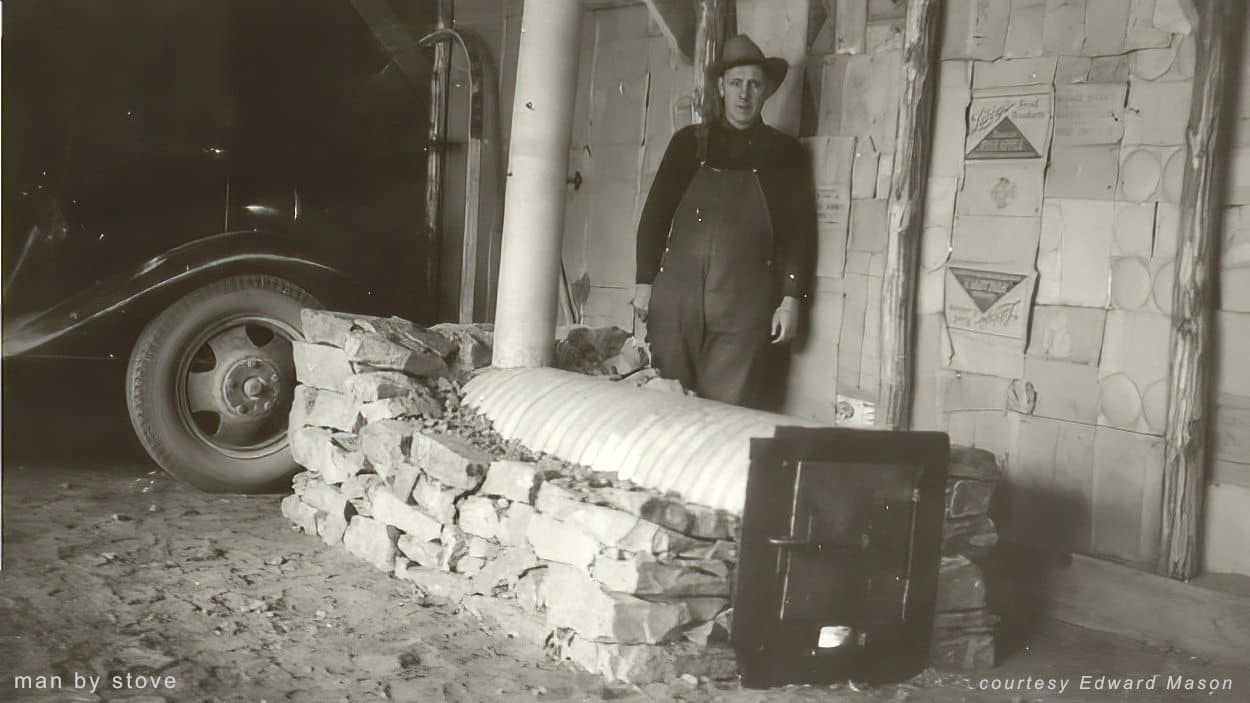 man by stove with car
