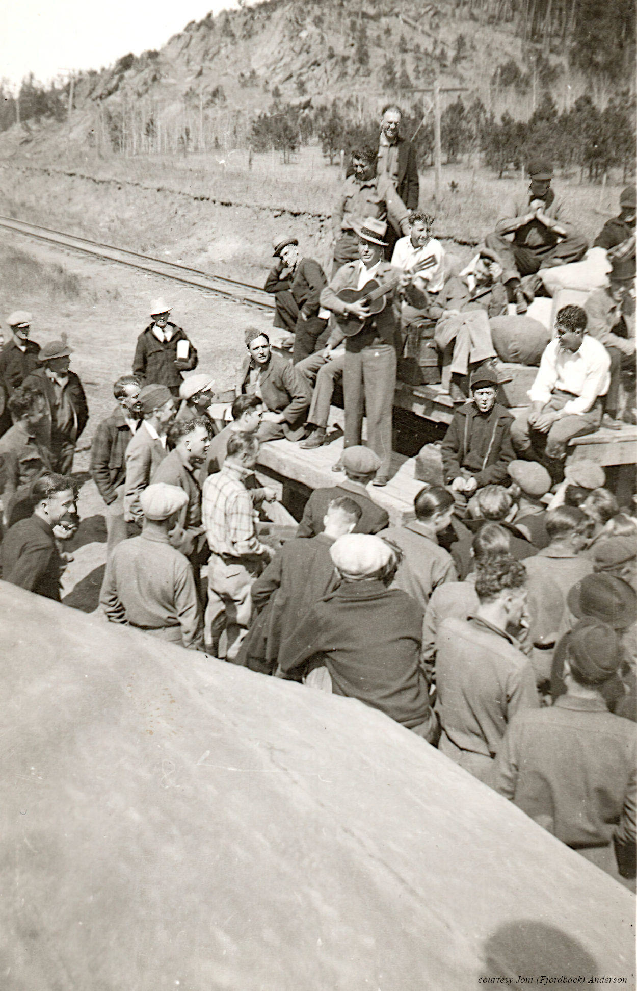 A man sings to the CCC men