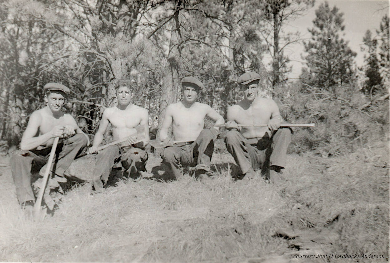 4 men no shirts with axes