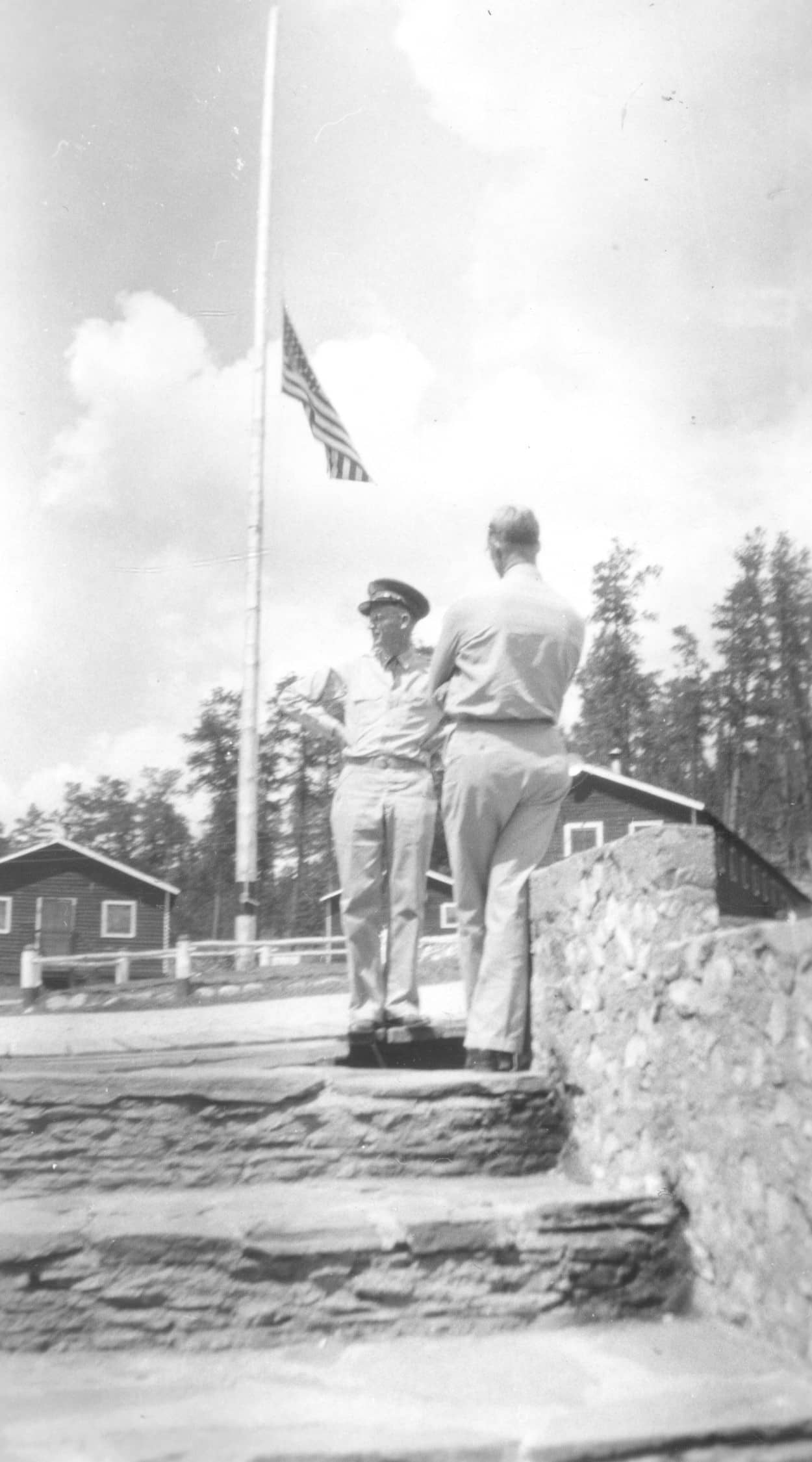 2 men by flagpole, 1941