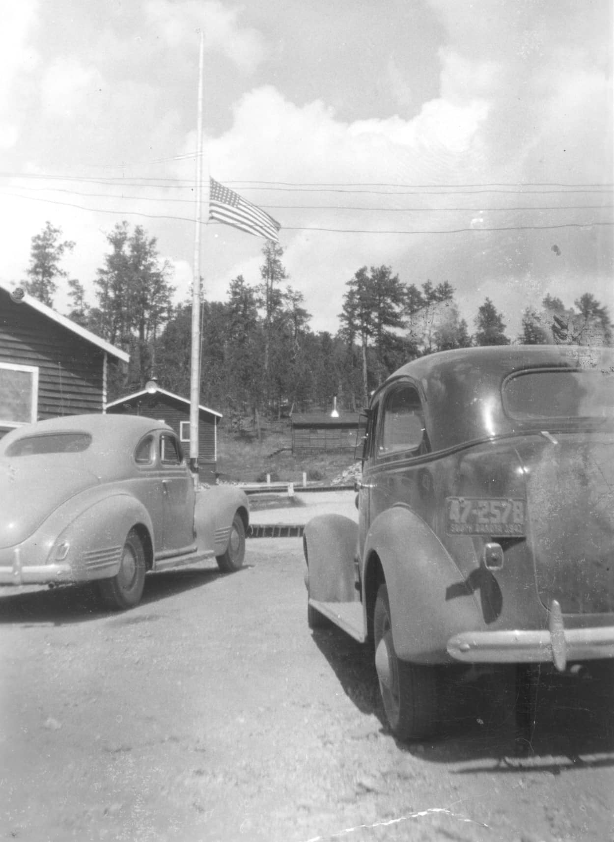 2 old cars, flagpole, 1941