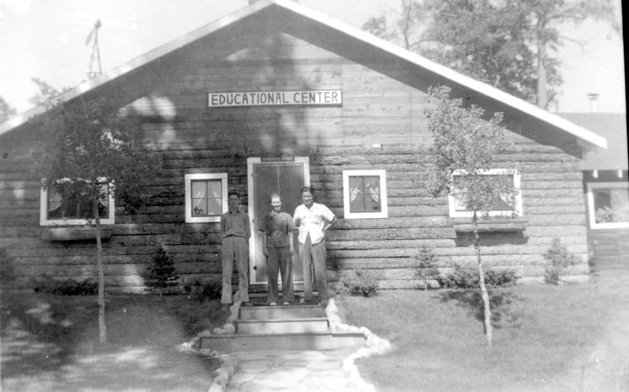 3 men standing in front of ed. center