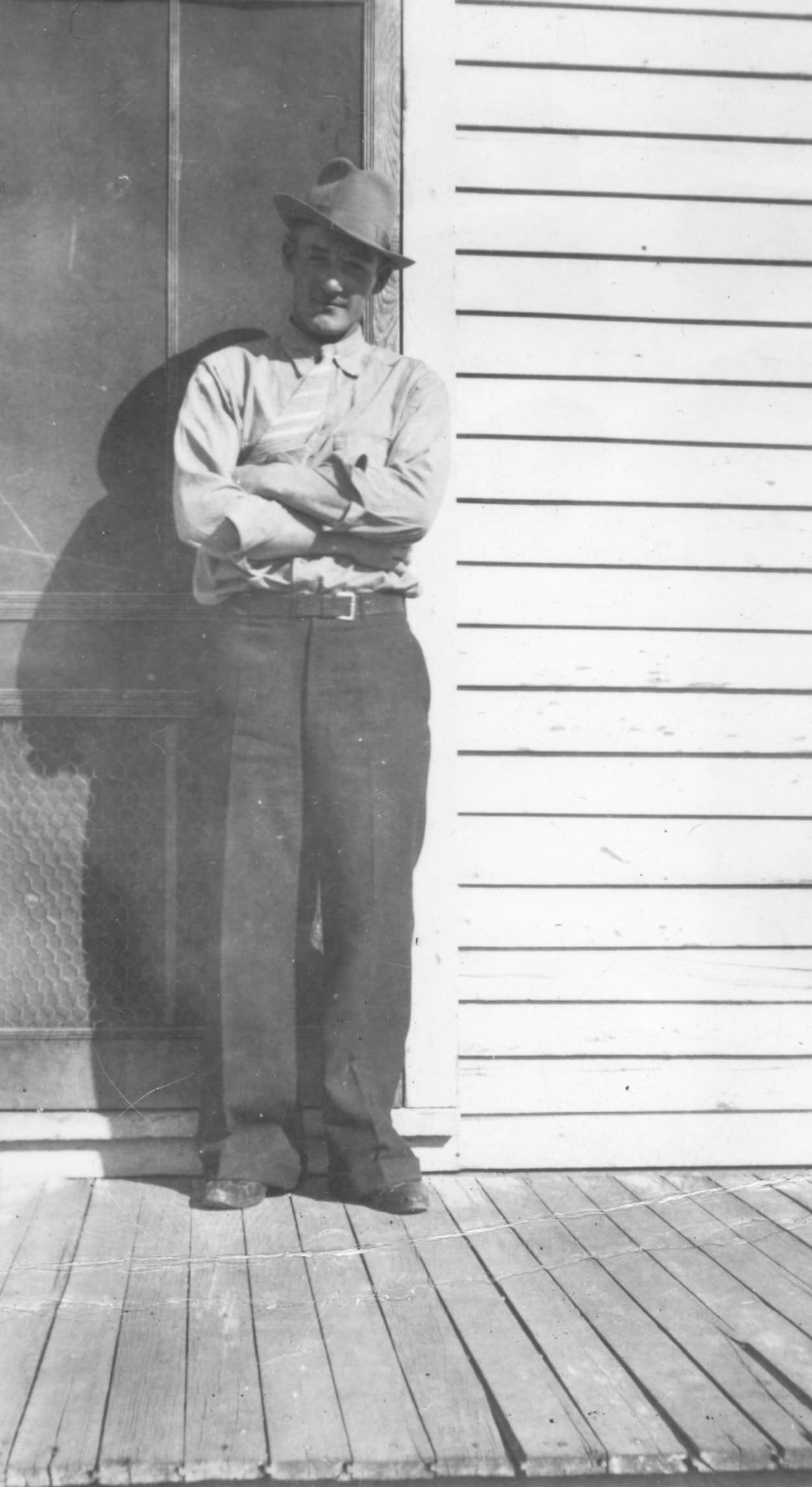 man standing with arms folded